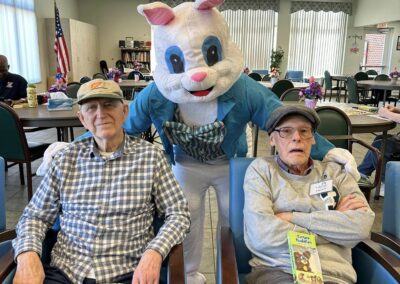 Two men pose with the Easter Bunny behind them