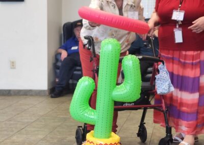 Two women throw a ring around a cactus ringtoss