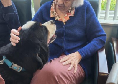 A woman pets a therapy dog