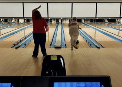 Two women enjoy a game of bowling