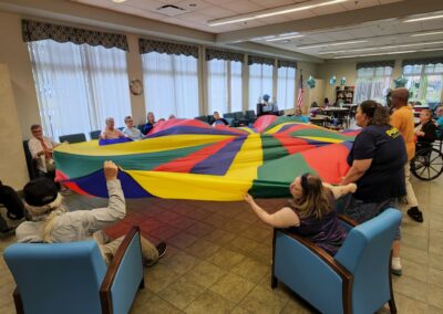 Participants play with a colorful tarp